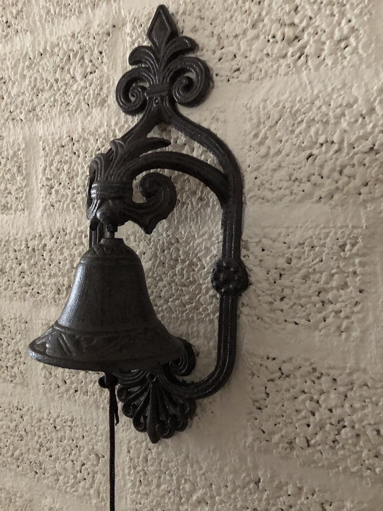Prachtig wandornament met een mooie deurpost bel met koord en klingel, cast iron bruin.